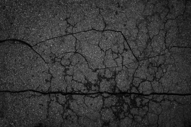 istock Crack background texture of rough asphalt top view 1389439515