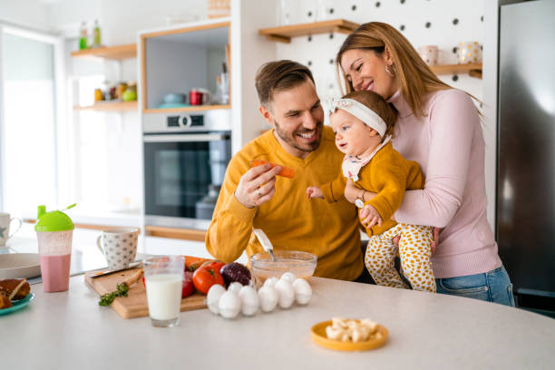 Happy family with children playing and cuddling at home stock photo