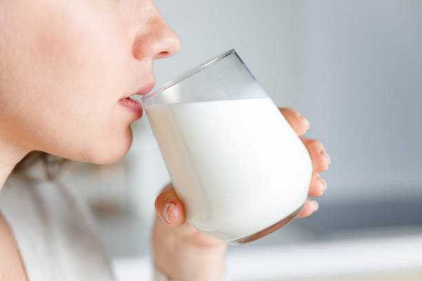 istock Young woman is drinking milk 1389441923