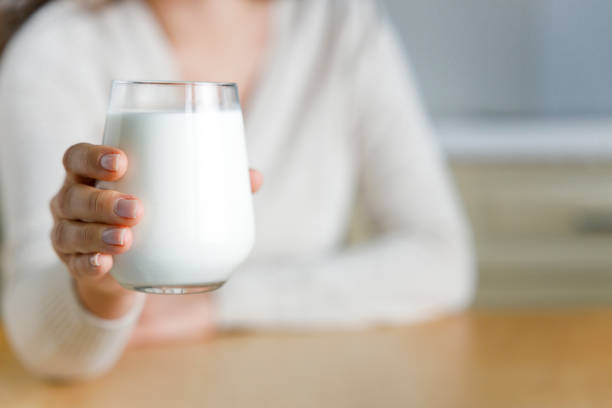 Young woman holding a glass of milk stock photo