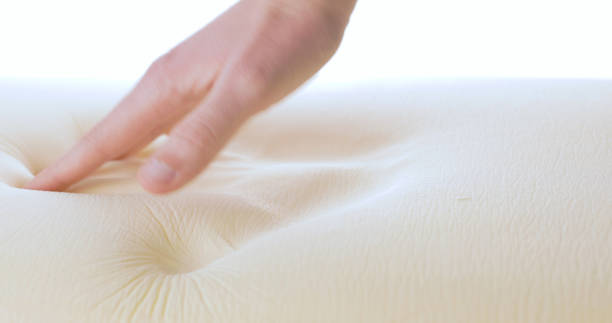 istock Touching and pressing a memory foam bed and pillow 1389444479