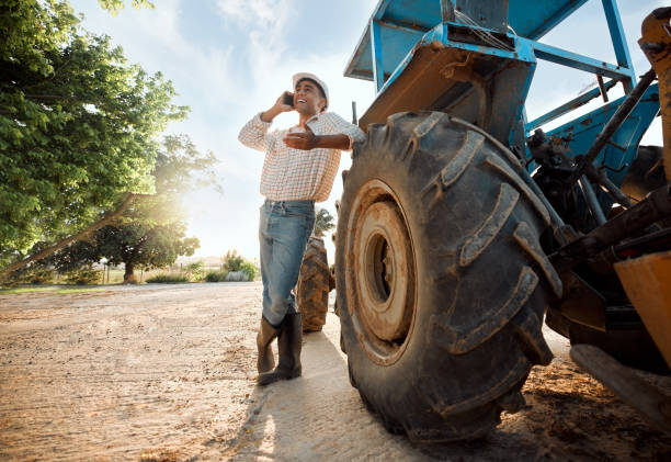 istock Shot of a young man talking on a cellphone while working on a farm 1389444596