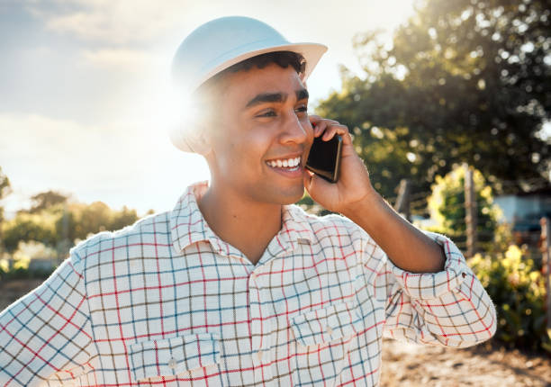 istock Shot of a young man talking on a cellphone while working on a farm 1389444626