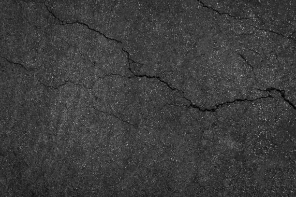 istock Crack background texture of rough asphalt top view 1389444727