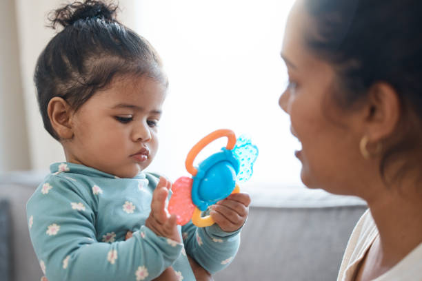 shot of an adorable little girl playing with a toy while bonding with her mother - mental health professional family couple psychiatrist imagens e fotografias de stock