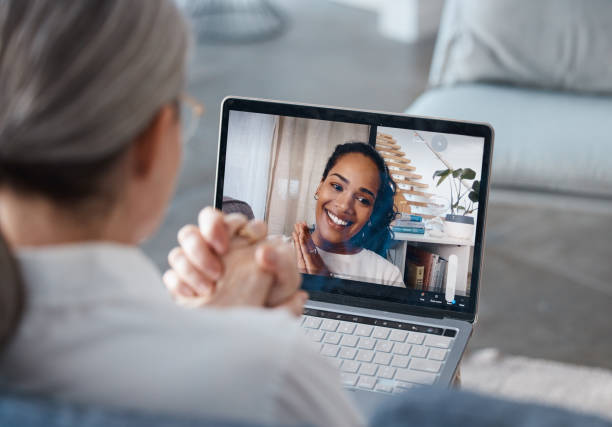 Shot of an unrecognisable psychologist sitting and using a laptop for an online consultation with her patient I caught myself mid-trigger yesterday! telemedicine stock pictures, royalty-free photos & images