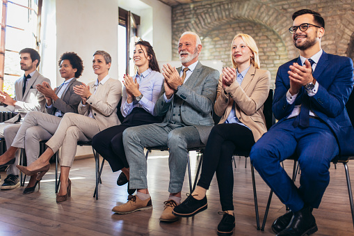 Happy business team applauding after successful group meeting