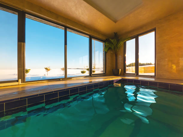 istock Empty indoors swimming pool with emerald green water 1389447194