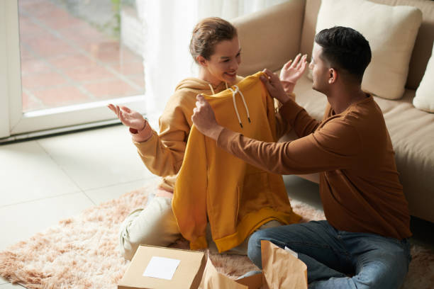 Couple Trying on Ordered Hoodies