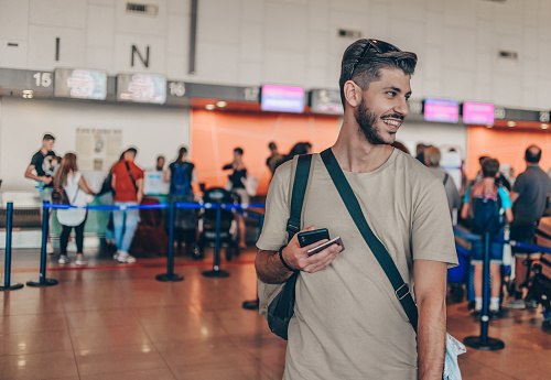 Handsome businessman going to departure lounge at airport