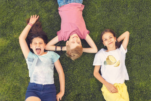 istock Happy kids having summer fun making funny faces outdoor 1389449182