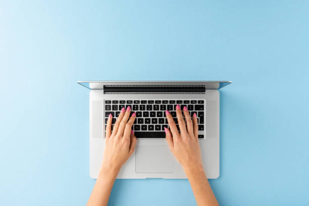istock Woman’s hands working on laptop. Business background with copyspace. Top view 1389449334
