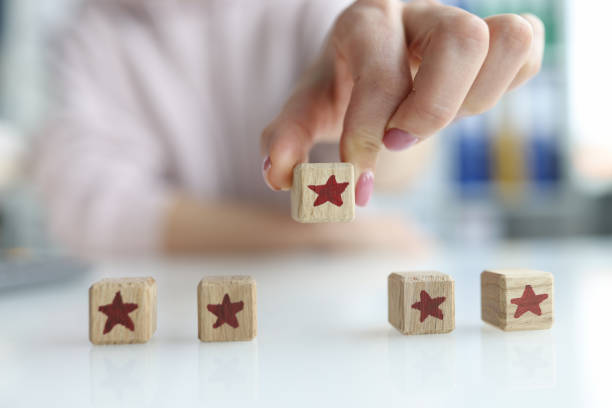 istock Client putting fifth star for quality service closeup 1389450485