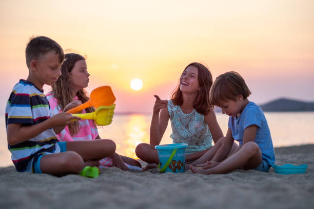 istock Children playing at the beach shores 1389451149