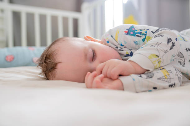 istock Portrait of cute sleeping baby boy 1389453295