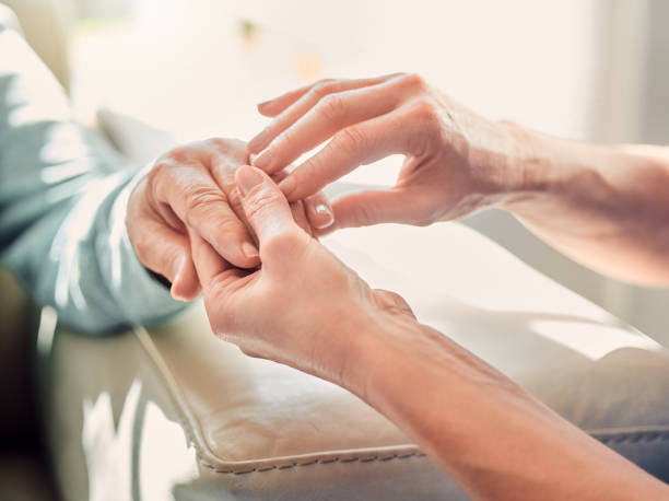 photo d’une infirmière méconnaissable massant la main d’une femme à la maison - rubbing human hand togetherness women photos et images de collection