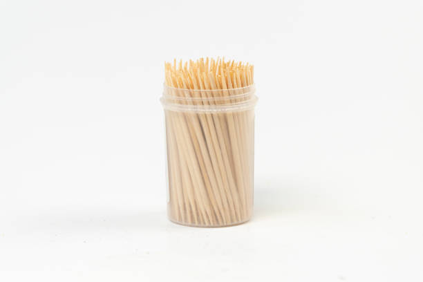 istock Box of toothpicks, toothpicks in a small cylindrical box isolated on white background, several dental pick top view 1389454502