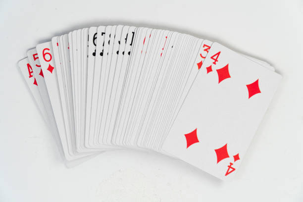 istock Playing cards pile, red diamond at the top, isolated on white background, top view 1389454562