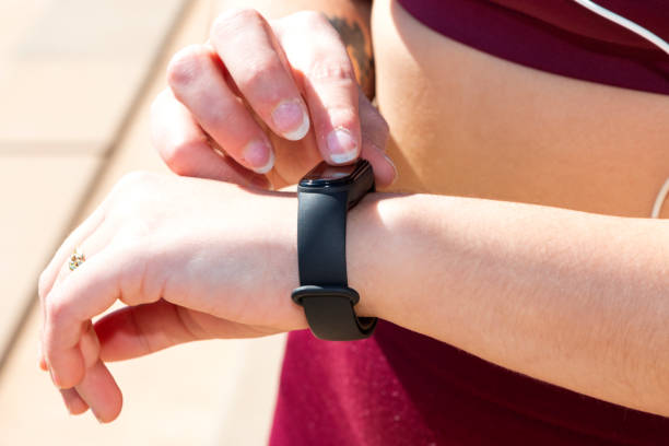 istock Close-up of girl touching her smart tracker 1389455099