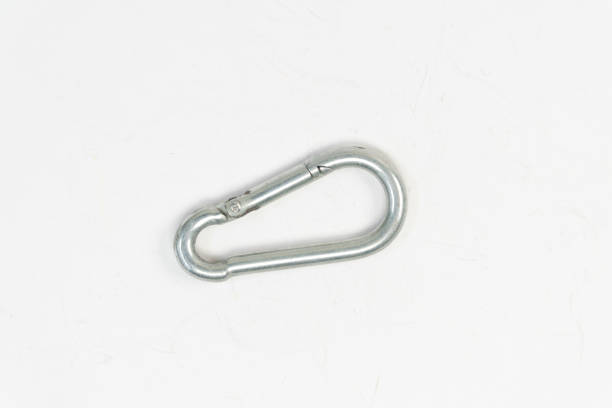 istock Mountain climbing snap hook clip isolated on white background, aluminium material bag hook, quick lock top view 1389455112