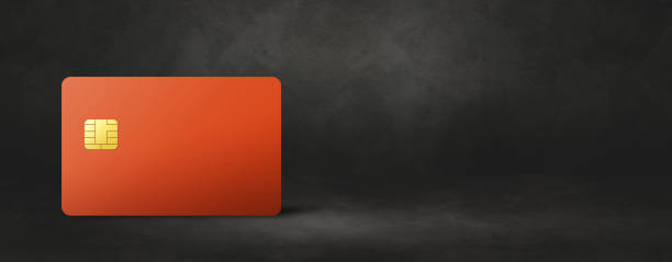 istock Orange credit card on a black concrete background 1389455155