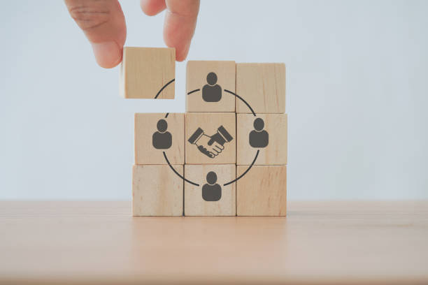 istock businessman's hand complete circle shape screen on wooden cube block for teamwork, brainstorming, cooperation for business growing concept 1389455247