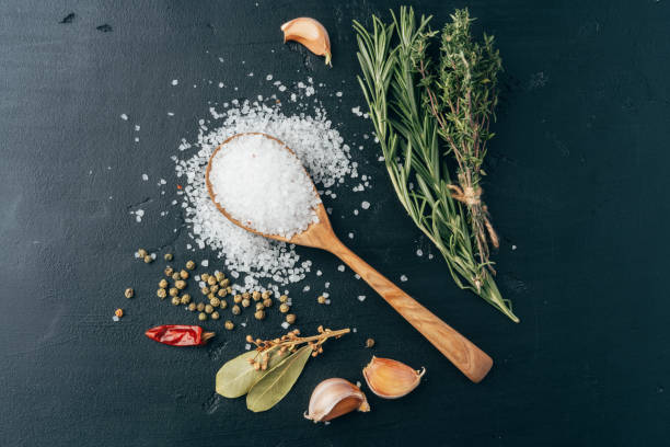 istock Wooden spoon and different spices on black background 1389456112