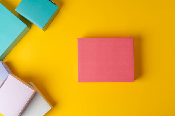 istock Colorful cardboard boxes on yellow background, copy space 1389456296