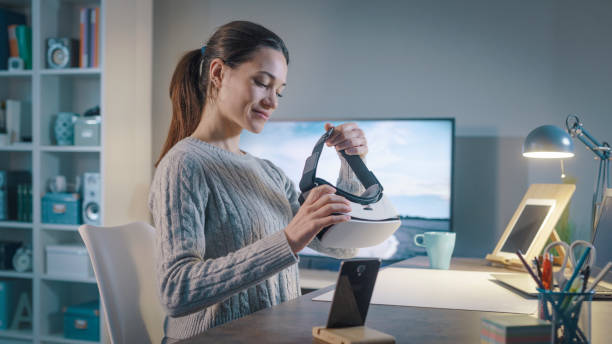 istock Young woman holding a VR headset 1389456388