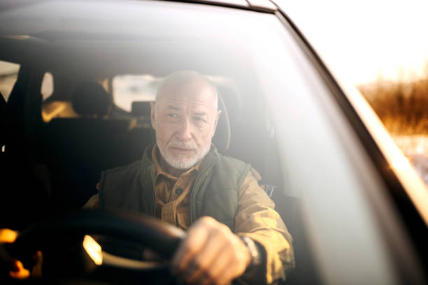 istock Handsome senior man driving car 1389456593