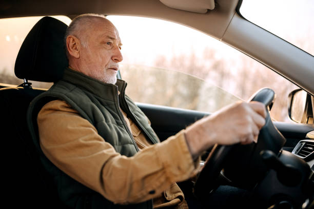 istock Handsome senior man driving car 1389456603