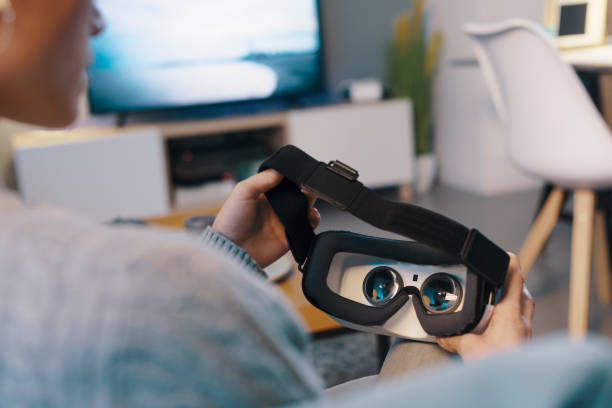 istock Woman holding a VR headset 1389456758