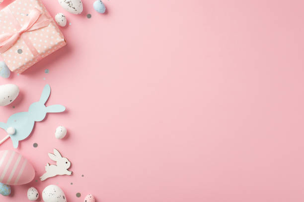 istock Top view photo of easter decorations giftbox confetti easter bunnies blue pink and white easter eggs on isolated pastel pink background with empty space 1389457376
