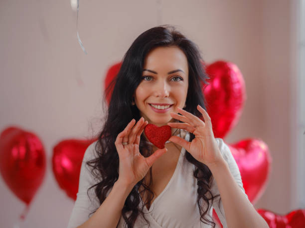 schöne glückliche junge frau, die den valentinstag feiert - model home house balloon sign stock-fotos und bilder