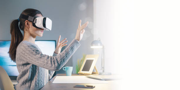 istock Young woman interacting with VR 1389457673
