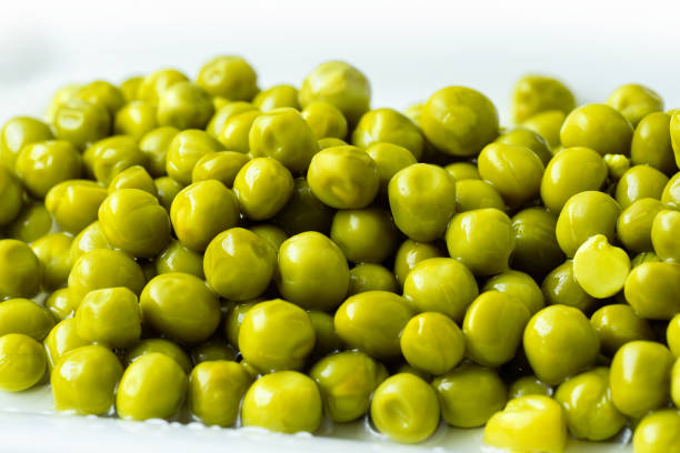istock White bowl with canned green peas. Fermented food 1389457864