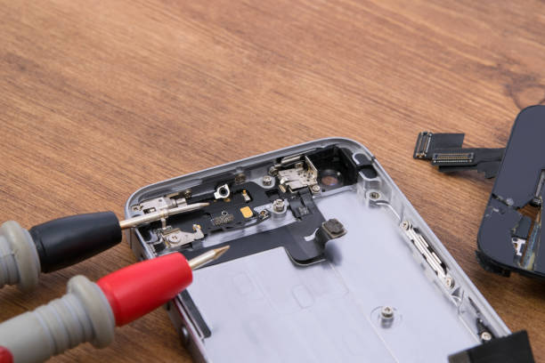 istock on a wooden table, close-up, troubleshooting using a smartphone tester to repair and replace the battery 1389459138