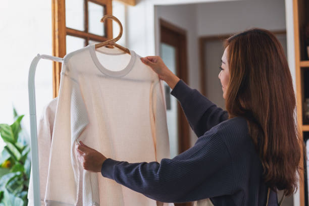 uma dona de casa lavando roupa, lavando e pendurando camisas no varal em casa - hang to dry - fotografias e filmes do acervo