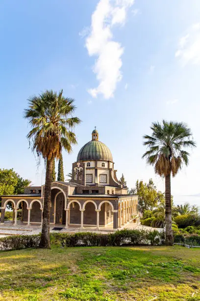 Magnificent monastery surrounded by columns and slender tall palms. The Church of the Beatitudes is a Catholic church of the Italian Franciscan convent on the Mount of Beatitudes.