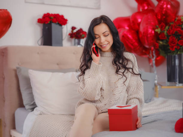 istock Smiling happy woman with gift box 1389462026