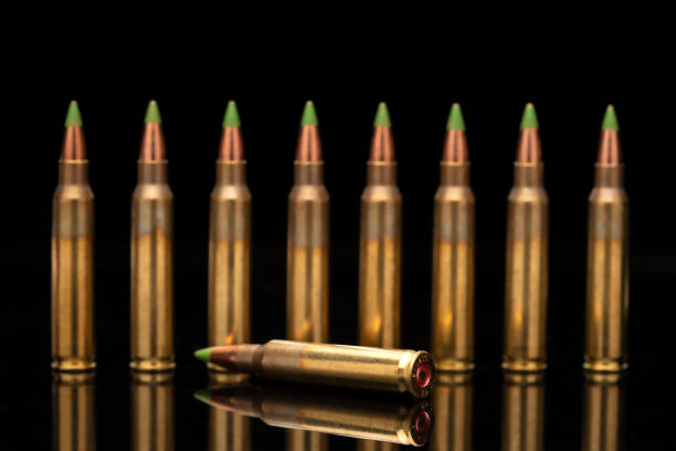 istock A group of 5.56 calibar, green tip bullets ordered into the line on black background 1389462948