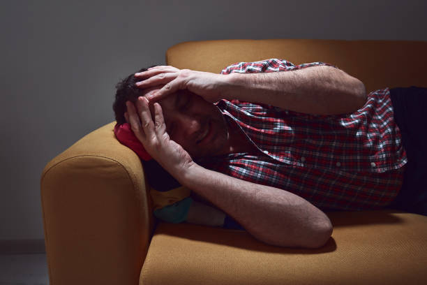 istock Man with headcahe pain at home. 1389463741
