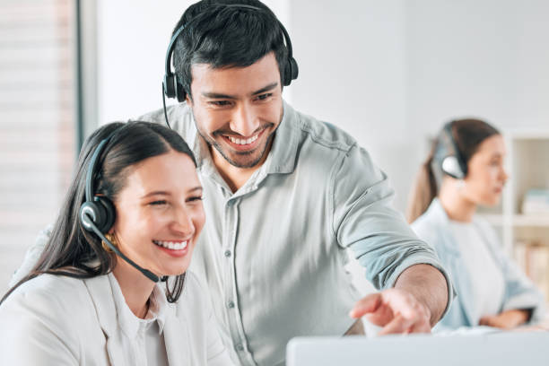 istock Shot of two call centre agents working together on a computer in an office 1389463937