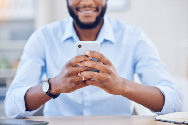 istock Shot of an unrecognizable businessperson using a phone at work 1389464012