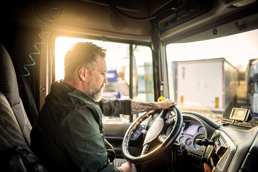 Photo of mid adult  man driving a truck