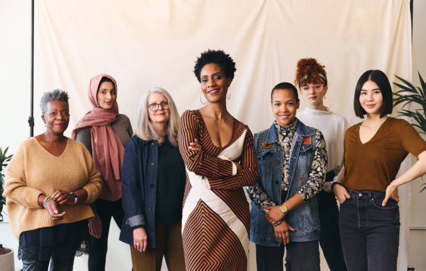 international women's day portrait of multiethnic mixed age range women looking confidently towards camera and smiling - autoridade imagens e fotografias de stock