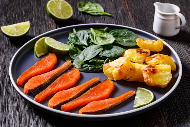 salmon slices with spinach leaves, roast potatoes - smoked salmon salt healthy lifestyle cold imagens e fotografias de stock