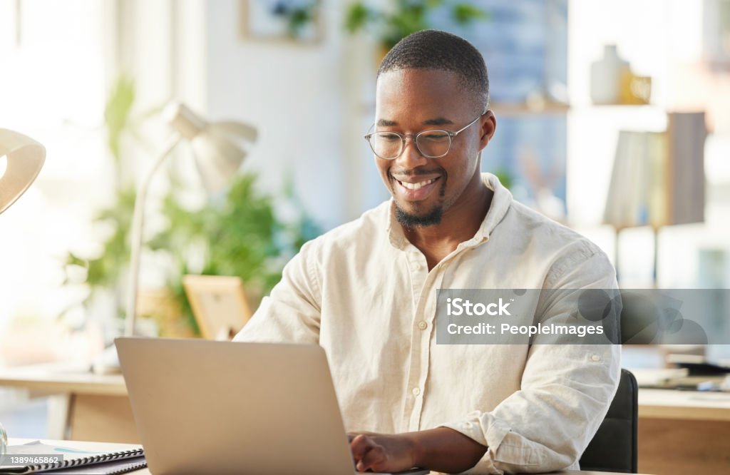 Shot of a young businessman working on his laptop at his desk Seizing the day Computer Stock Photo