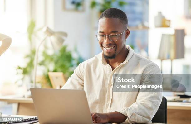 Shot Of A Young Businessman Working On His Laptop At His Desk Stock Photo - Download Image Now