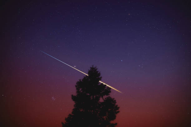 istock Stars, meteor trail on evening sky. 1389466063